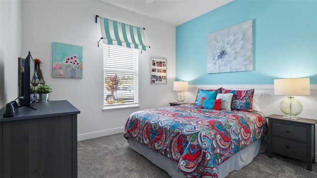 carpeted bedroom featuring baseboards