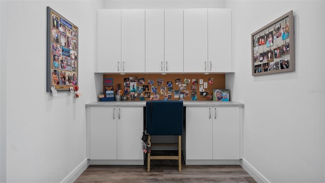 bar featuring wood finished floors and baseboards