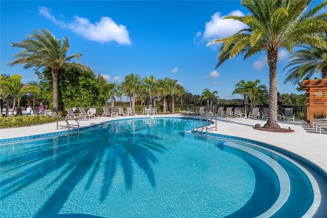 community pool featuring a patio area and fence