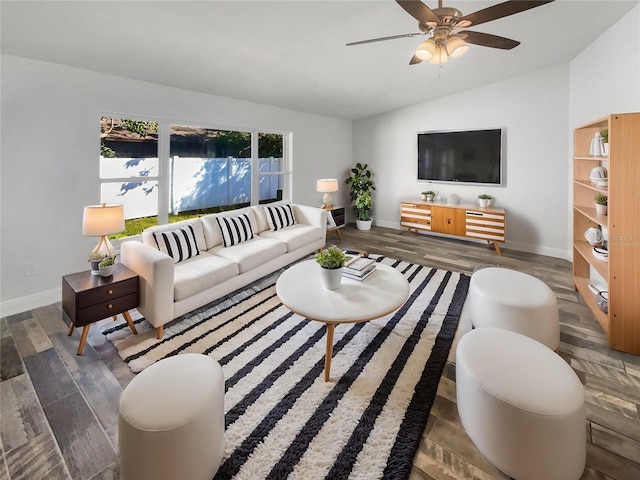 living area with lofted ceiling, wood finished floors, a ceiling fan, and baseboards