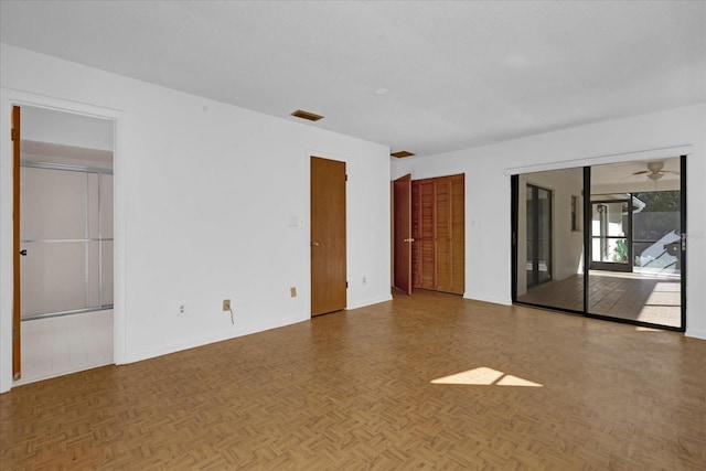 unfurnished room with ceiling fan and visible vents