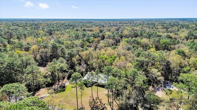 drone / aerial view featuring a wooded view