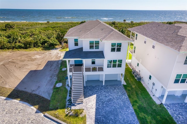 birds eye view of property featuring a water view and a beach view