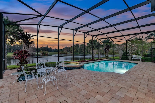 view of swimming pool featuring a patio area and glass enclosure