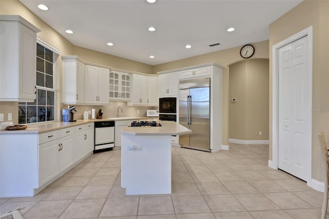 kitchen with a center island, white cabinetry, black appliances, and recessed lighting