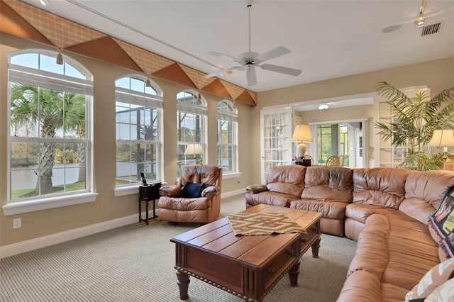 sunroom with ceiling fan and visible vents