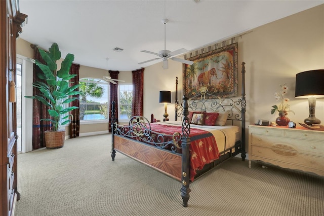 carpeted bedroom featuring visible vents and a ceiling fan