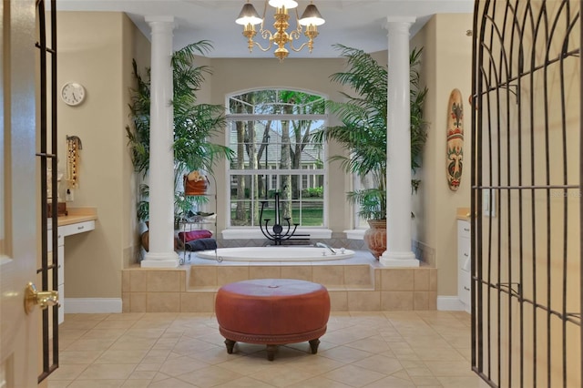 bathroom with tile patterned flooring, decorative columns, and a bath