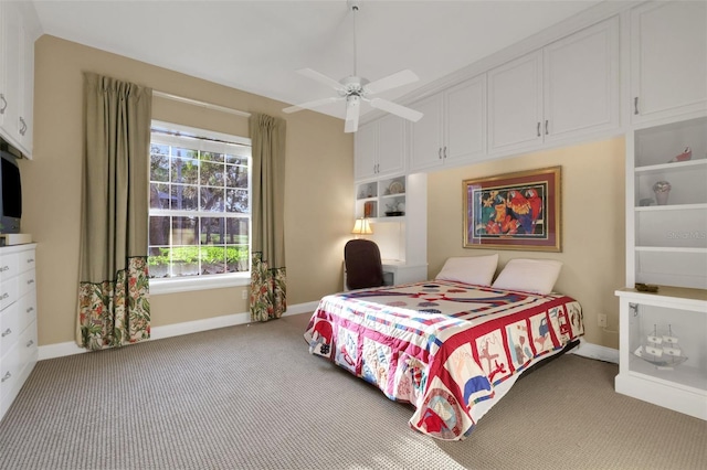 carpeted bedroom with a ceiling fan and baseboards