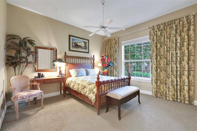 bedroom with light colored carpet, ceiling fan, and baseboards