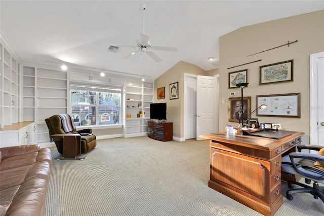 carpeted office space featuring built in features, visible vents, a ceiling fan, vaulted ceiling, and baseboards