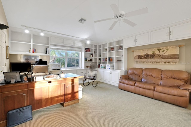 office area with light carpet, built in shelves, vaulted ceiling, and visible vents