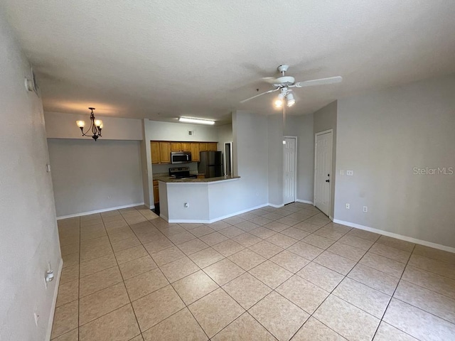 unfurnished living room featuring light tile patterned floors, ceiling fan with notable chandelier, baseboards, and a textured ceiling