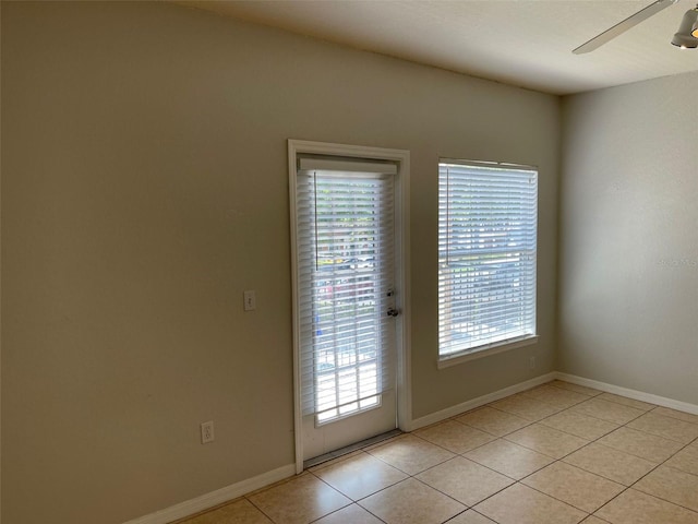 entryway featuring light tile patterned floors, baseboards, and ceiling fan