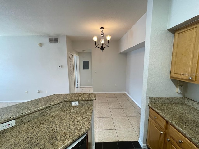 kitchen featuring dark stone countertops, baseboards, visible vents, an inviting chandelier, and light tile patterned flooring