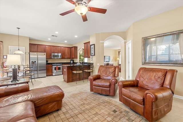 living room with arched walkways, ceiling fan, light tile patterned floors, recessed lighting, and visible vents