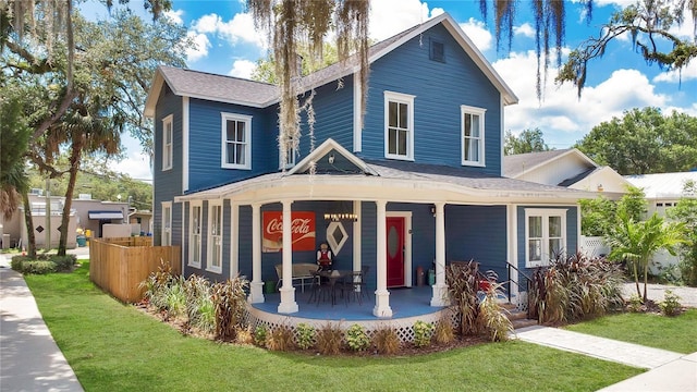 view of front of house featuring a front yard and covered porch