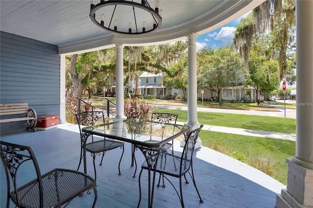 view of patio with a porch and outdoor dining space