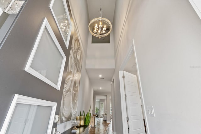 foyer with a high ceiling, recessed lighting, and an inviting chandelier