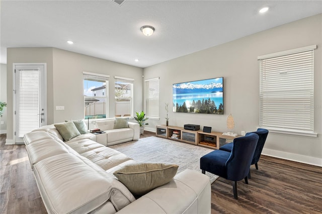 living room with baseboards, wood finished floors, and recessed lighting