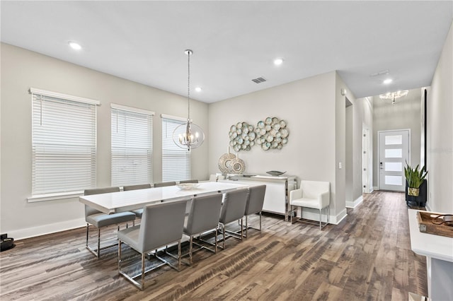 dining room with dark wood-style floors, baseboards, and an inviting chandelier