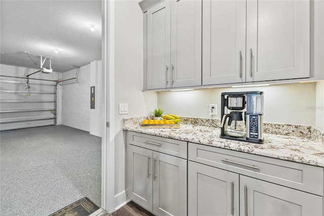 interior space featuring electric panel and a textured ceiling