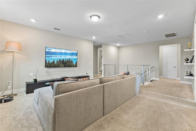 carpeted living area with recessed lighting, visible vents, and baseboards