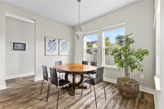 dining room featuring an inviting chandelier, baseboards, and wood finished floors