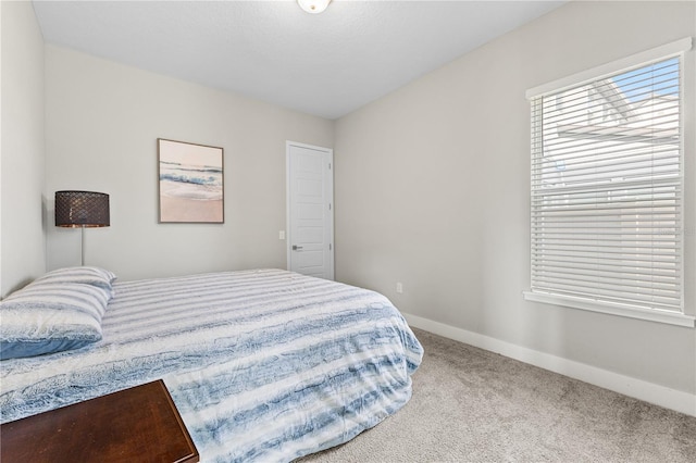 bedroom with carpet flooring and baseboards