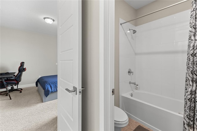 bathroom with shower / tub combo, toilet, and baseboards