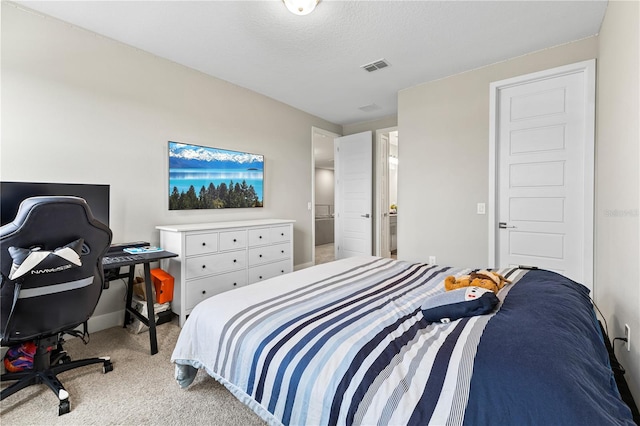 bedroom with a textured ceiling, visible vents, and light colored carpet