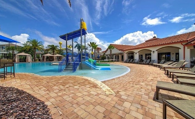9947 Summerlake Groves St, Winter Garden, FL 34787 - community pool with a water slide, a patio area, and a water play area