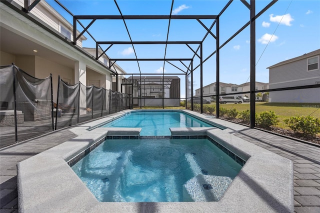 view of swimming pool with glass enclosure, a pool with connected hot tub, and a patio