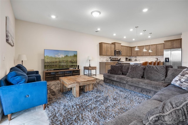 living area featuring light tile patterned flooring and recessed lighting