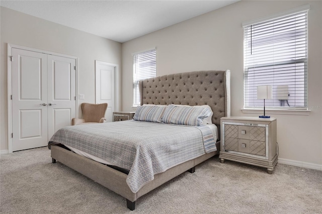 bedroom featuring carpet and baseboards