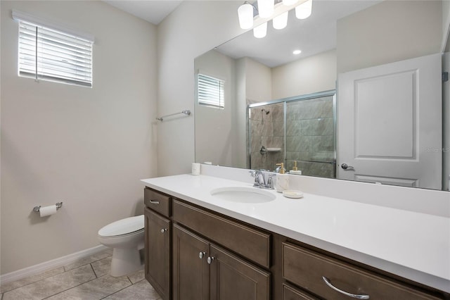 full bathroom with toilet, vanity, baseboards, a shower stall, and tile patterned floors