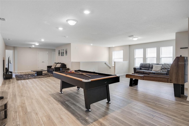 game room featuring billiards, a textured ceiling, wood finished floors, and visible vents