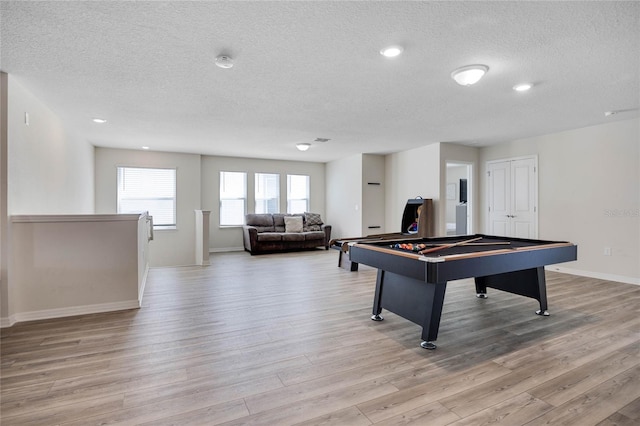 rec room with a textured ceiling, billiards, light wood-style flooring, and baseboards