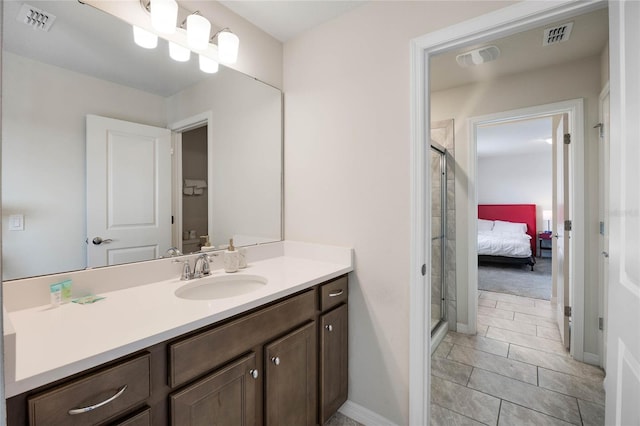 ensuite bathroom with visible vents, a shower stall, and vanity