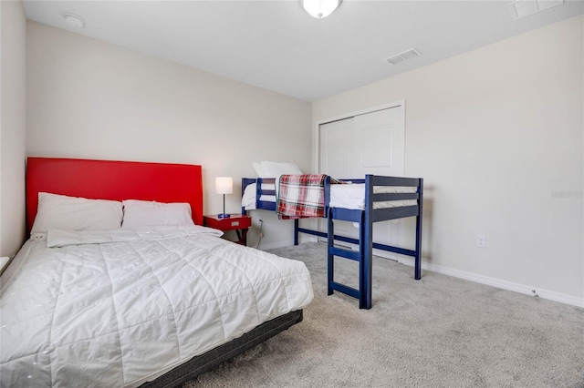 bedroom featuring baseboards, a closet, visible vents, and carpet flooring