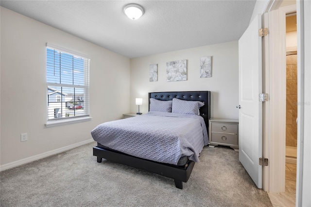 carpeted bedroom with a textured ceiling and baseboards