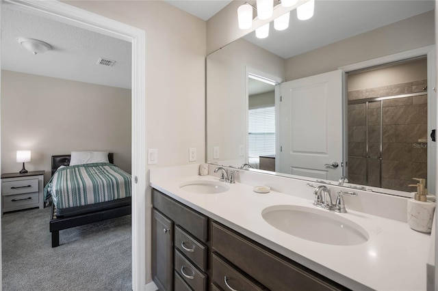 bathroom featuring visible vents, a sink, ensuite bath, and double vanity