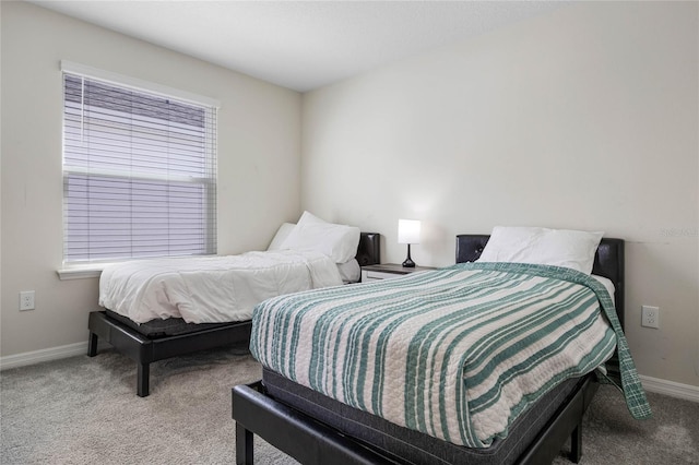 bedroom with carpet floors and baseboards