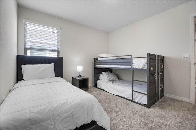 bedroom with carpet flooring and baseboards