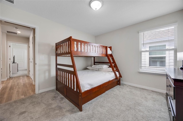 carpeted bedroom with visible vents and baseboards