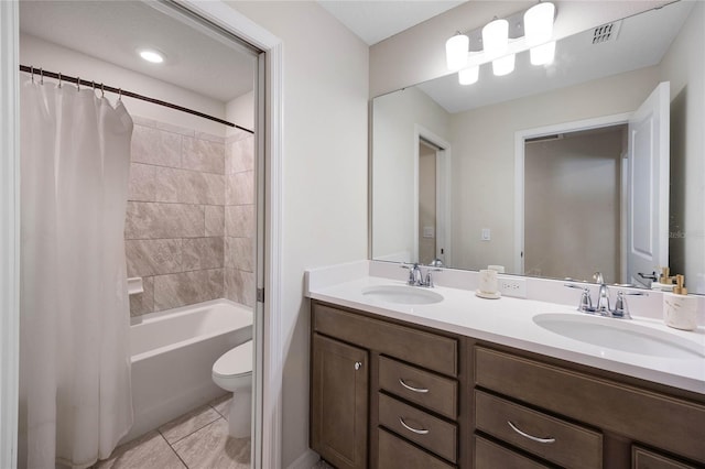 full bath featuring double vanity, visible vents, a sink, and tile patterned floors