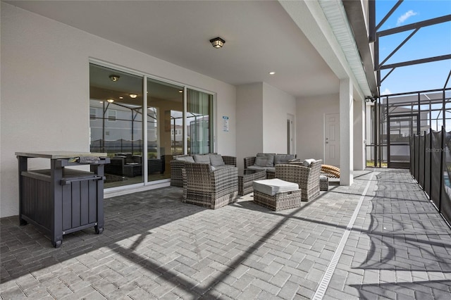 view of patio / terrace featuring glass enclosure and an outdoor living space