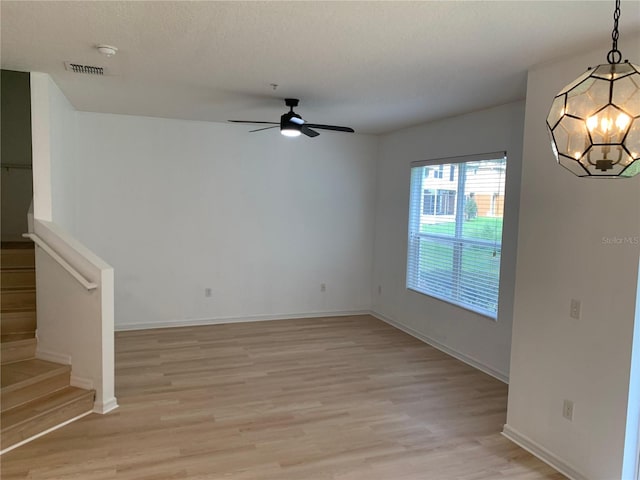 interior space with baseboards, visible vents, stairway, and light wood finished floors