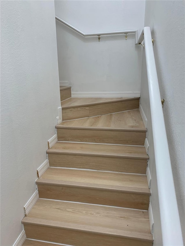 stairway featuring baseboards