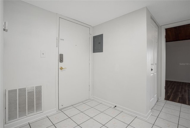 spare room featuring electric panel, visible vents, and baseboards